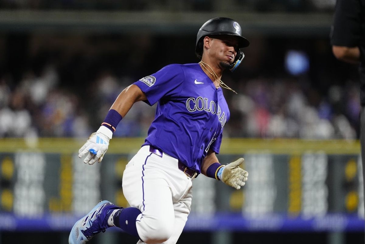 Aug 20, 2025; Denver, Colorado, USA; Colorado Rockies third baseman Orlando Arcia (11) heads home to score a run in the eighth inning against the Los Angeles Dodgers at Coors Field. Mandatory Credit: Ron Chenoy-Imagn Images