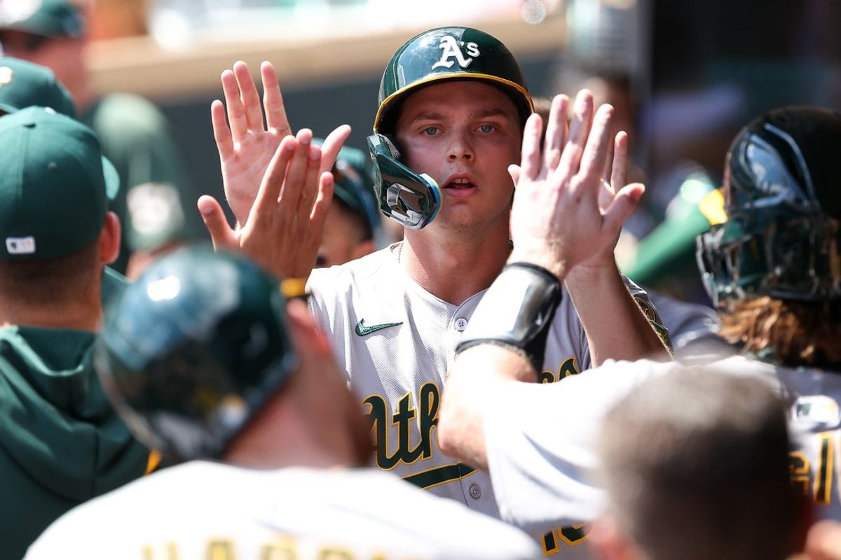 Aug 21, 2025; Minneapolis, Minnesota, USA; Athletics first baseman Nick Kurtz (16) celebrates after scoring on a double hit by center fielder Lawrence Butler (4) during the second inning against the Minnesota Twins at Target Field. Mandatory Credit: Matt Krohn-Imagn Images