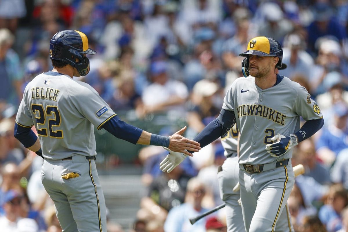 Aug 21, 2025; Chicago, Illinois, USA; Milwaukee Brewers second baseman Brice Turang (2) celebrates with designated hitter Christian Yelich (22) after hitting a two-run home run against the Chicago Cubs during the second inning at Wrigley Field. Mandatory Credit: Kamil Krzaczynski-Imagn Images