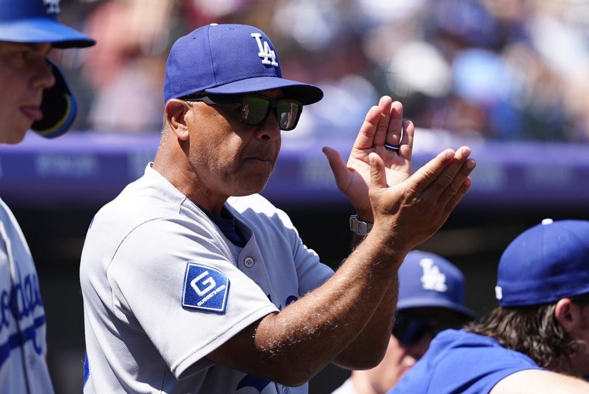 Aug 20, 2025; Denver, Colorado, USA; Los Angeles Dodgers manager Dave Roberts (30) claps before the game against the Colorado Rockies in the inning at Coors Field. Mandatory Credit: Ron Chenoy-Imagn Images