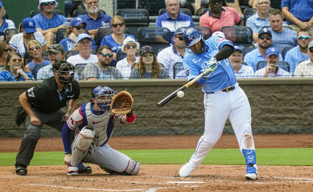 Aug 21, 2025; Kansas City, Missouri, USA; Kansas City Royals designated hitter Salvador Perez (13) hits an RBI single during the third inning against the Texas Rangers at Kauffman Stadium. Mandatory Credit: Jay Biggerstaff-Imagn Images