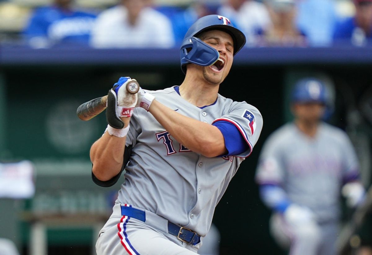 Aug 21, 2025; Kansas City, Missouri, USA; Texas Rangers shortstop Corey Seager (5) reacts after fouling a ball off of his leg during the ninth inning against the Kansas City Royals at Kauffman Stadium. Mandatory Credit: Jay Biggerstaff-Imagn Images