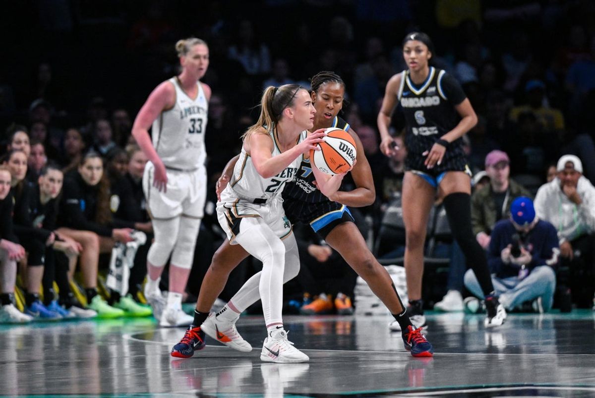 Aug 21, 2025; Brooklyn, New York, USA; New York Liberty guard Sabrina Ionescu (20) looks to pass the ball as Chicago Sky guard Ariel Atkins (7) defends during the first half at Barclays Center. Mandatory Credit: John Jones-Imagn Images