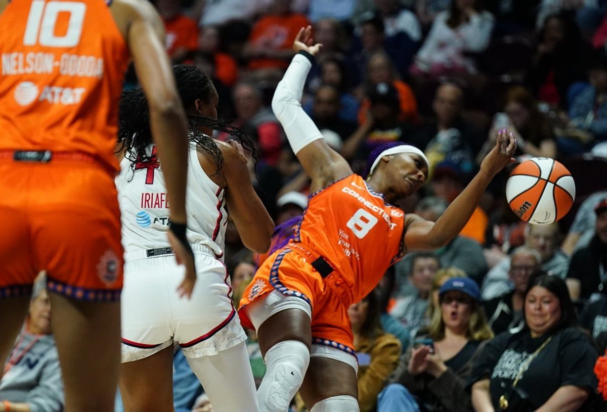 Aug 21, 2025; Uncasville, Connecticut, USA; Connecticut Sun forward Aaliyah Edwards (8) is fouled by Washington Mystics forward Kiki Iriafen (44) in the first half at Mohegan Sun Arena. Mandatory Credit: David Butler II-Imagn Images