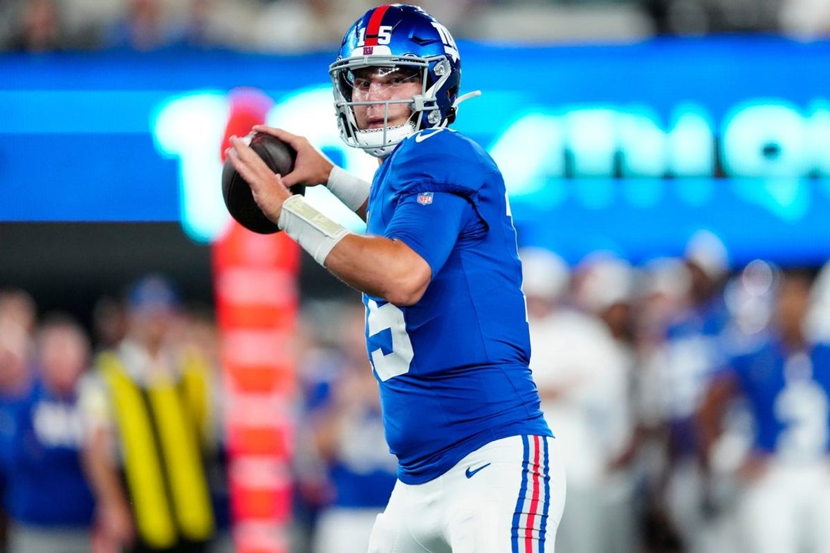 New York Giants quarterback Tommy DeVito (15) gets ready to throw a pass, Thursday, August 21, 2025, in East Rutherford.