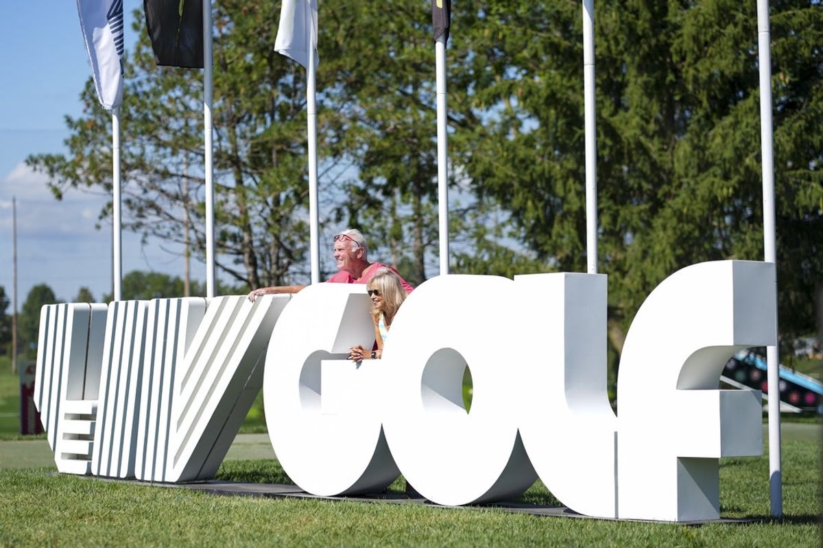 Fans pose for a photo at a LIV Golf event in Michigan in July 2025. (Aaron Doster-Imagn Images)