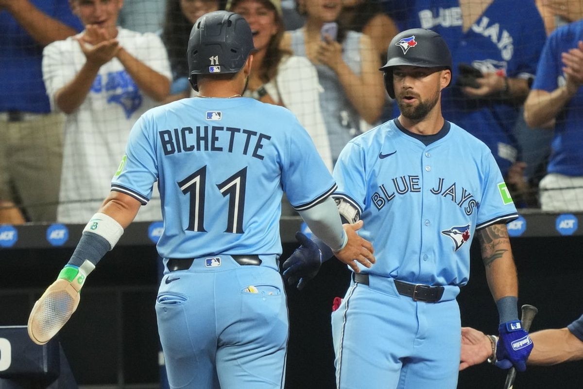 Aug 22, 2025; Miami, Florida, USA; Toronto Blue Jays shortstop Bo Bichette (11) is congratulated by left fielder Nathan Lukes (38) after scoring a run in the first inning against the Miami Marlins at loanDepot Park. Mandatory Credit: Jim Rassol-Imagn Images