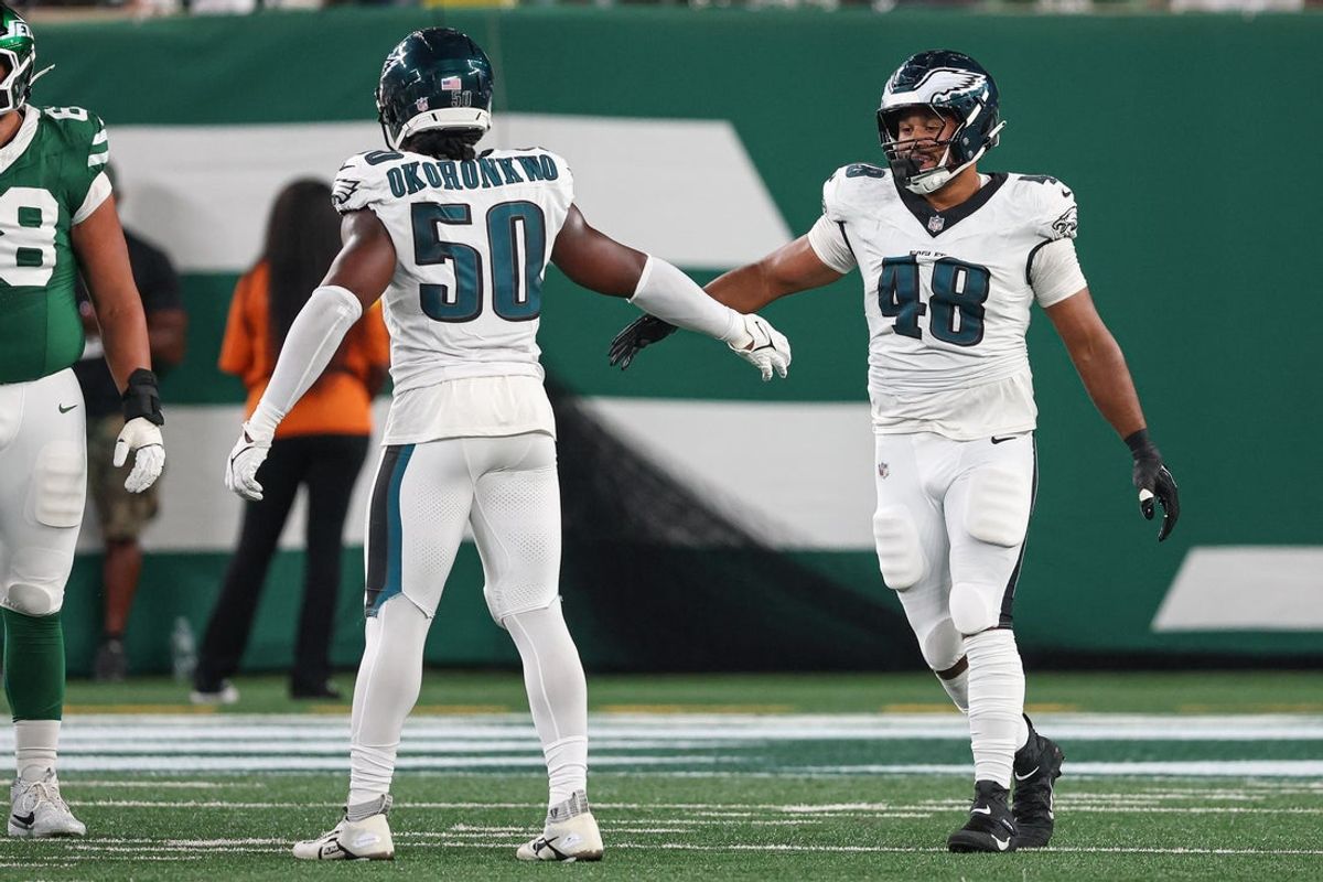 Aug 22, 2025; East Rutherford, New Jersey, USA; Philadelphia Eagles linebacker Patrick Johnson (48) celebrates a sack with defensive end Ogbo Okoronkwo (50) during the first half against the New York Jets at MetLife Stadium. Mandatory Credit: Vincent Carchietta-Imagn Images