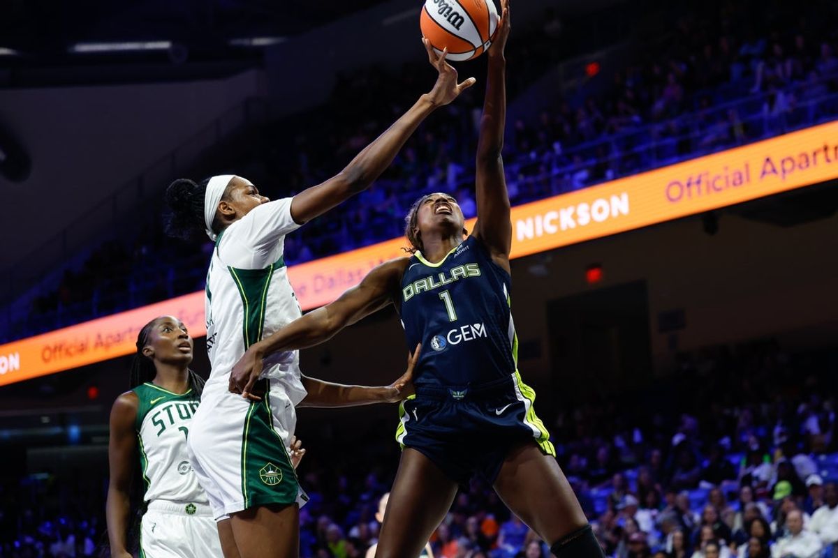 Aug 22, 2025; Arlington, Texas, USA; Dallas Wings forward Diamond Miller (1) has her shot blocked by Seattle Storm center Dominique Malonga (14) during the second half at College Park Center. Mandatory Credit: Chris Jones-Imagn Images