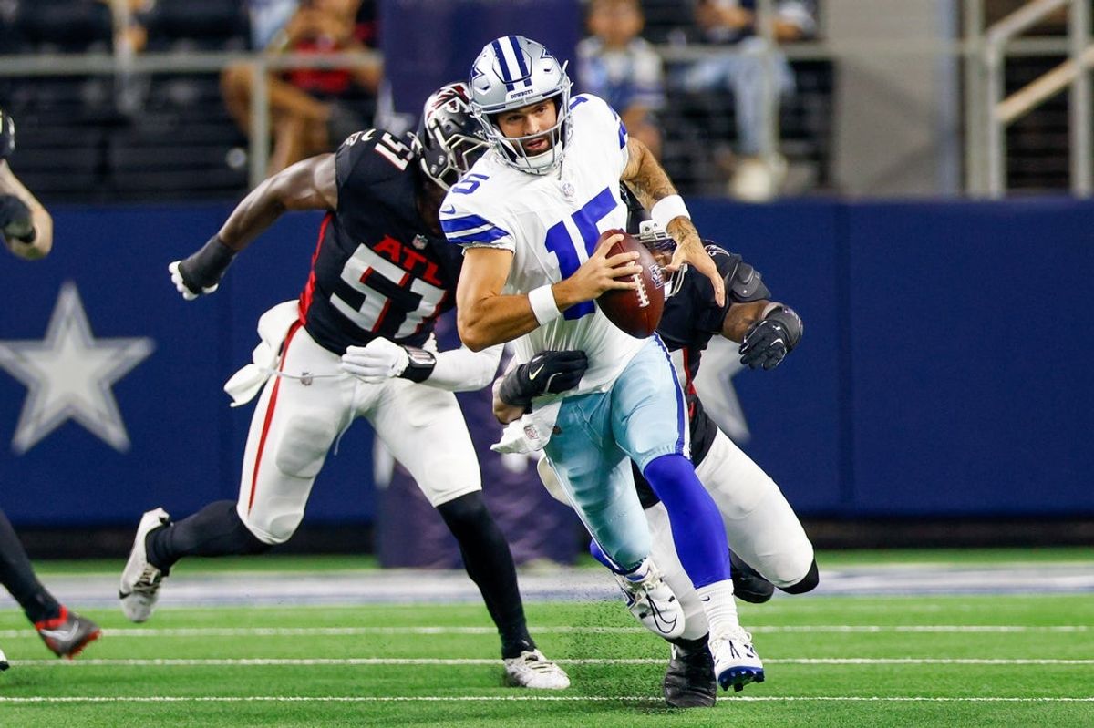 Aug 22, 2025; Arlington, Texas, USA; Dallas Cowboys quarterback Will Grier (15) is tackled by Atlanta Falcons linebacker Ronnie Perkins (50) during the fourth quarter at AT&T Stadium. Mandatory Credit: Andrew Dieb-Imagn Images