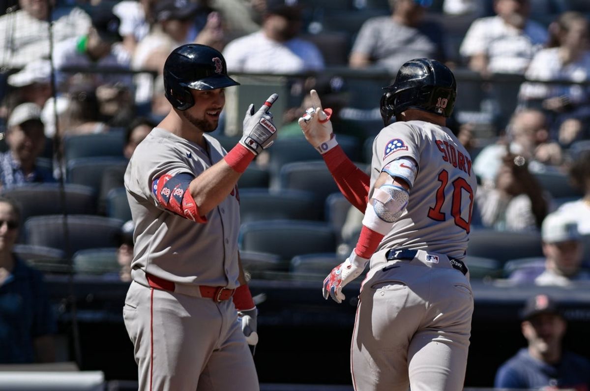 Aug 23, 2025; Bronx, New York, USA; Boston Red Sox shortstop Trevor Story (10) is greeted at home plate by first baseman Nathaniel Lowe (37) after hitting a solo home run against the New York Yankees during the fifth inning at Yankee Stadium. Mandatory Credit: John Jones-Imagn Images