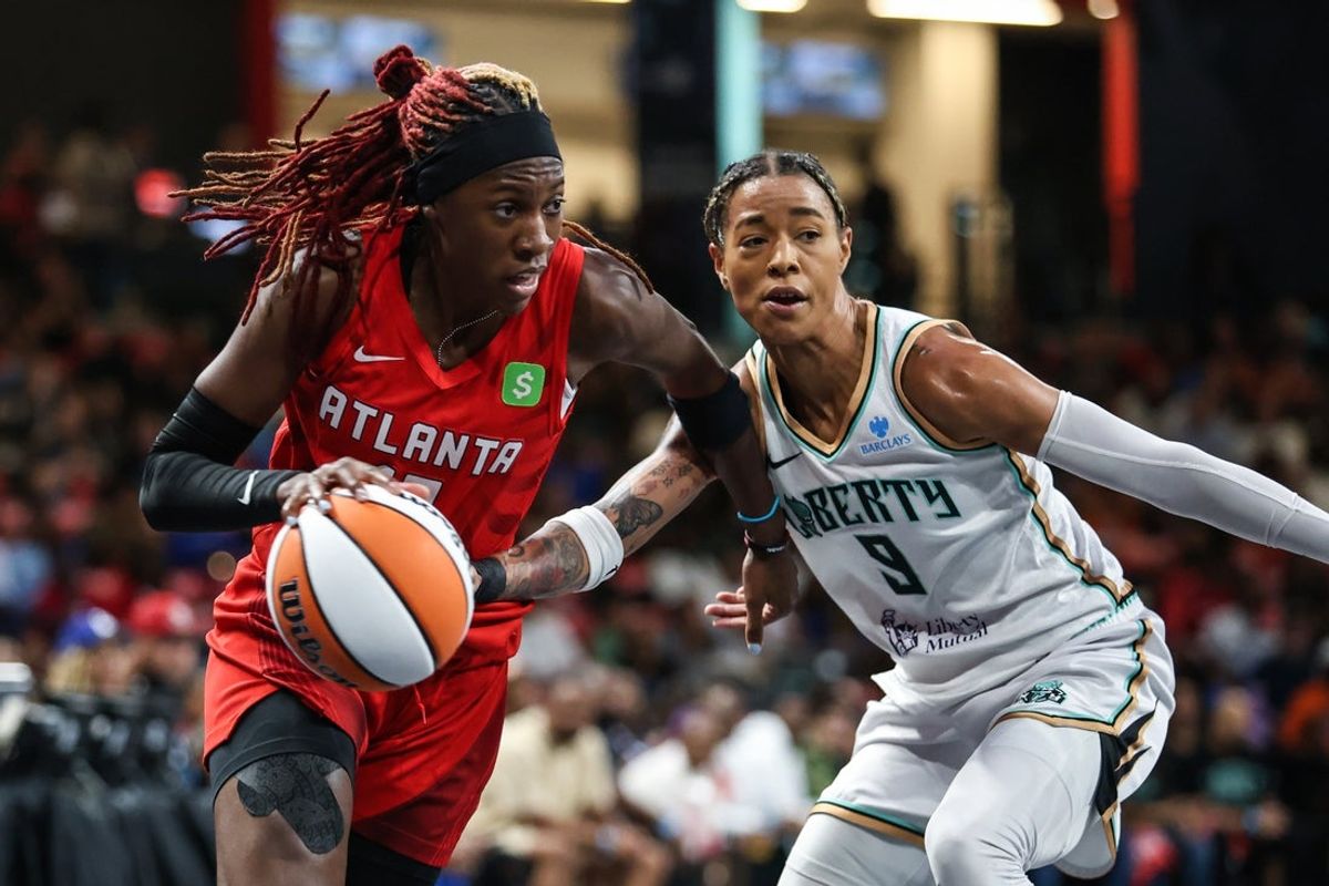 Aug 23, 2025; College Park, Georgia, USA; Atlanta Dream guard Rhyne Howard (10) drives the ball towards the basket against New York Liberty guard Natasha Cloud (9) during the first quarter at Gateway Center Arena at College Park. Mandatory Credit: Jordan Godfree-Imagn Images