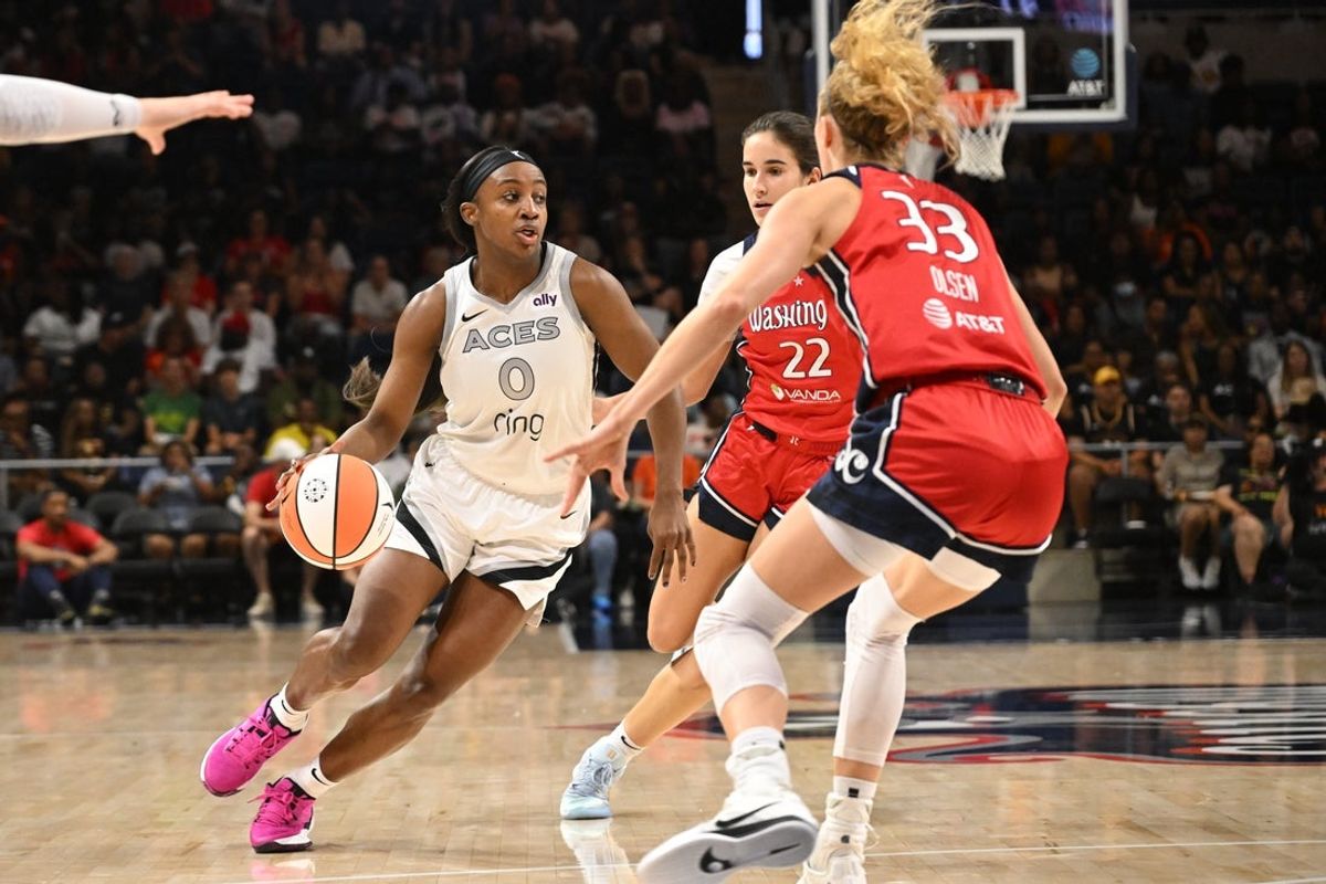 Aug 23, 2025; Washington, District of Columbia, USA; Las Vegas Aces guard Jackie Young (0) dribbles the ball in between Washington Mystics guard Sonia Citron (22) and guard Lucy Olsen (33) during the first quarter at CareFirst Arena. Mandatory Credit: Rafael Suanes-Imagn Images