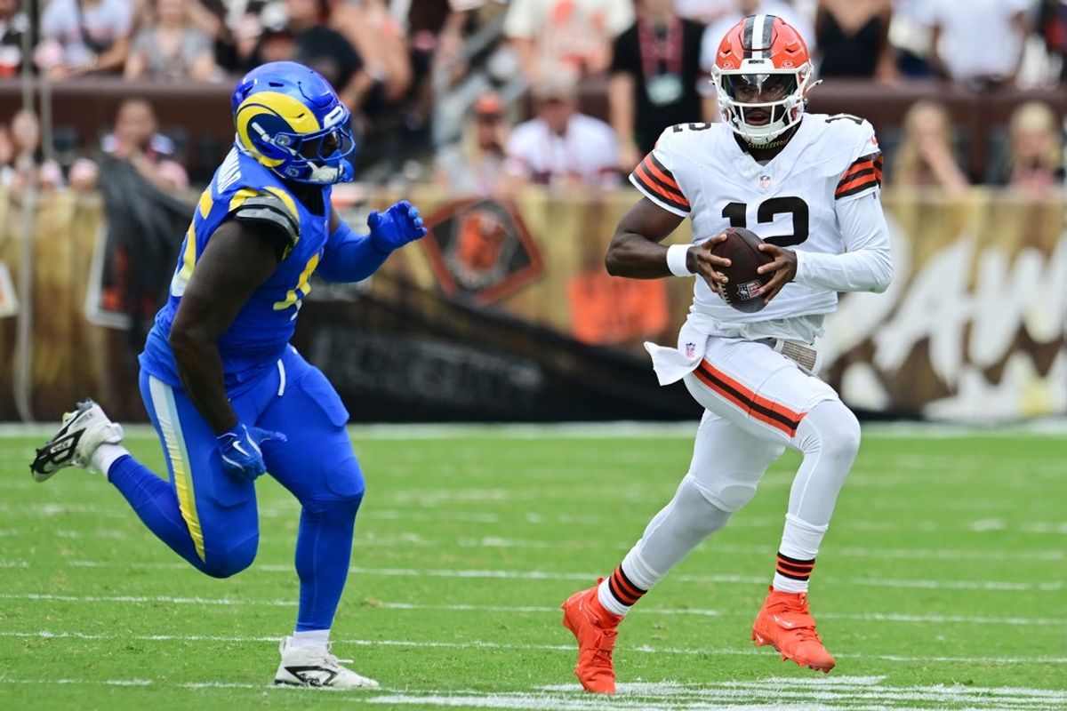 Aug 23, 2025; Cleveland, Ohio, USA; Los Angeles Rams linebacker Jamil Muhammad (45) chases Cleveland Browns quarterback Shedeur Sanders (12) during the second half at Huntington Bank Field. Mandatory Credit: Ken Blaze-Imagn Images