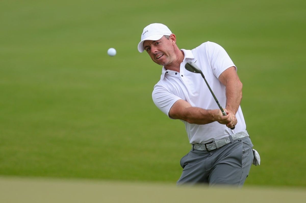 Aug 23, 2025; Atlanta, Georgia, USA; Rory McIlroy chips on the 17th green during the third round of the TOUR Championship golf tournament. Mandatory Credit: Brett Davis-Imagn Images