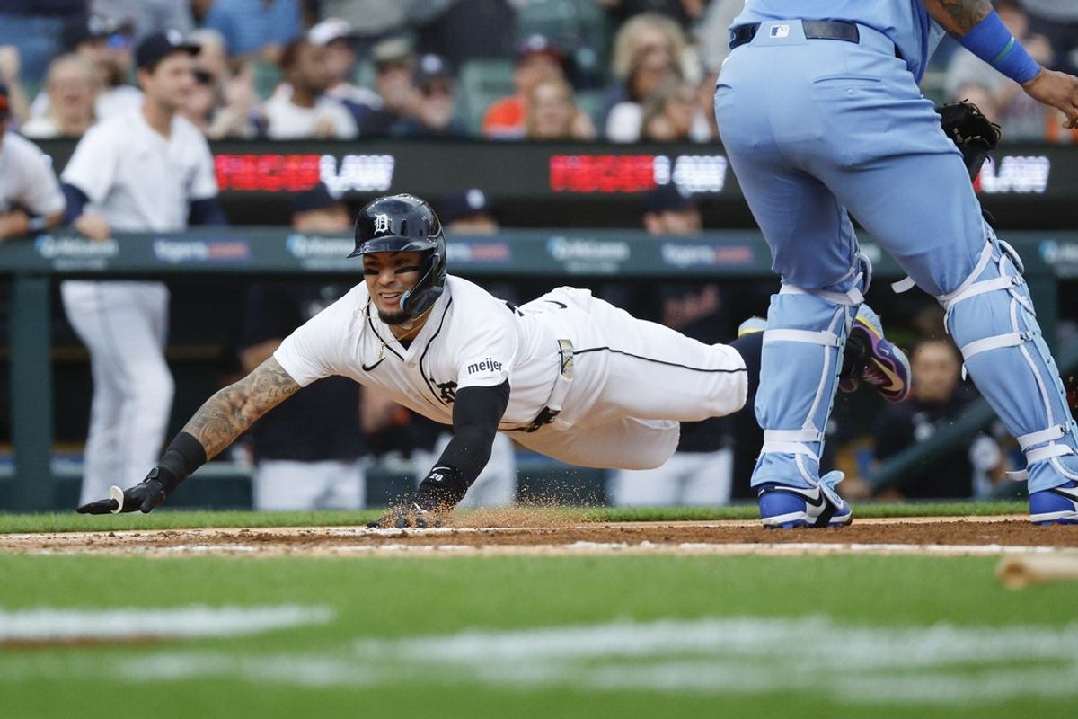 Aug 23, 2025; Detroit, Michigan, USA; Detroit Tigers outfielder Javier Báez (28) slides into home plate for a run during the fourth inning against the Kansas City Royals at Comerica Park. Mandatory Credit: Brian Bradshaw Sevald-Imagn Images