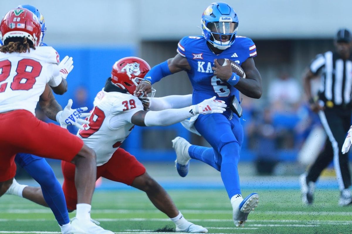 Kansas Jayhawks quarterback Jalon Daniels (6) runs for yards during the game between Fresno State and Kansas at David Booth Kansas Memorial Stadium.