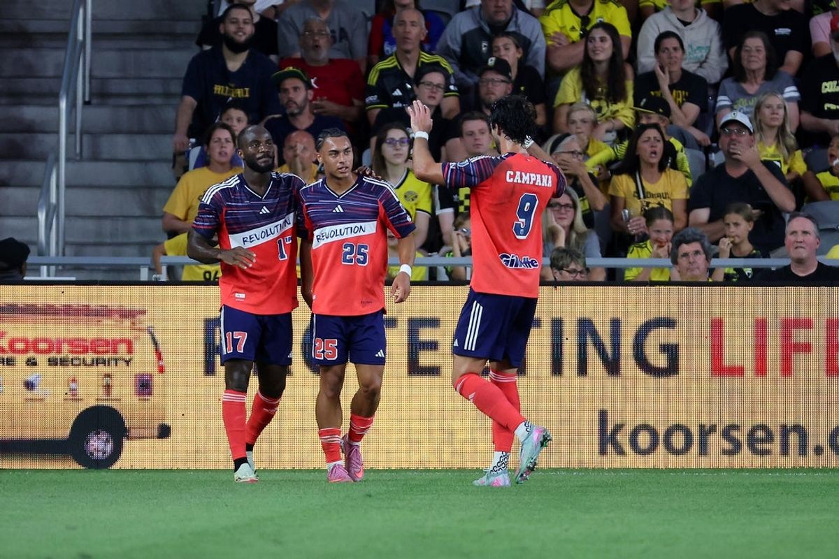 Aug 23, 2025; Columbus, Ohio, USA;  New England Revolution forward Ignatius Ganago (17) and defender Peyton Miller (25) celebrate the goal with forward Leonardo Campana (9) during the first half against the Columbus Crew at Lower.com Field. Mandatory Credit: Joseph Maiorana-Imagn Images