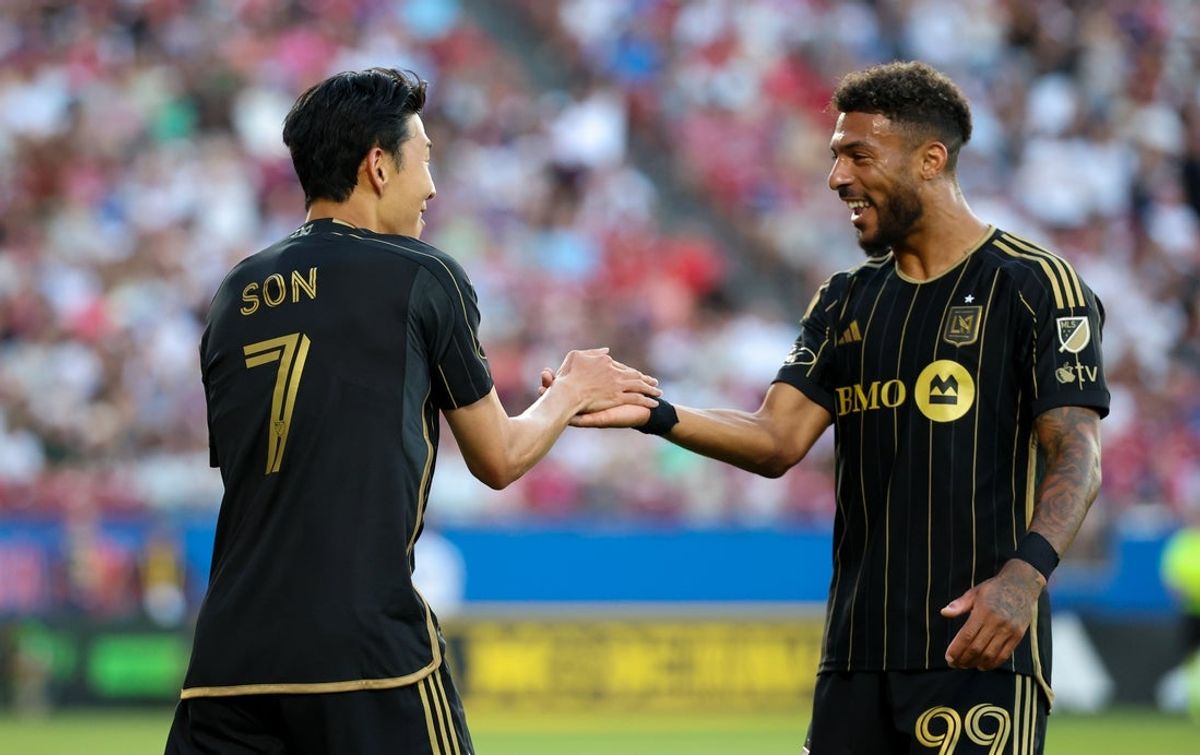 Aug 23, 2025; Frisco, Texas, USA;  Los Angeles FC forward Son Heung-Min (7) celebrates withLos Angeles FC forward Denis Bouanga (99) after scoring a goal on a free kick during the first half against FC Dallas at Toyota Stadium. Mandatory Credit: Kevin Jairaj-Imagn Images