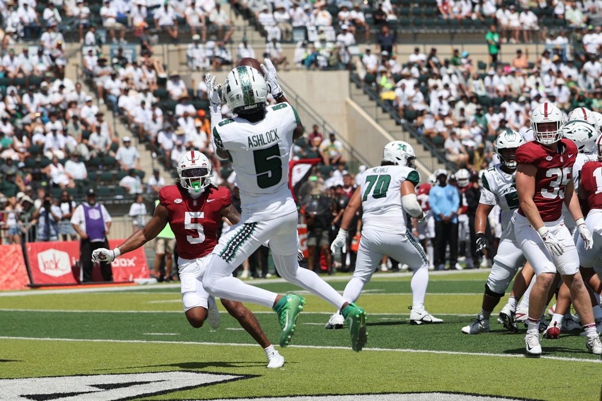 Aug 23, 2025; Honolulu, Hawaii, USA; Hawaii Rainbow Warriors wide receiver Pofele Ashlock (5) pulls in a touchdown catch over Stanford Cardinal safety Jay Green (5) during the first half of an NCAA college football game at Clarence T.C. Ching Athletics Complex. Mandatory Credit: Marco Garcia-Imagn Images