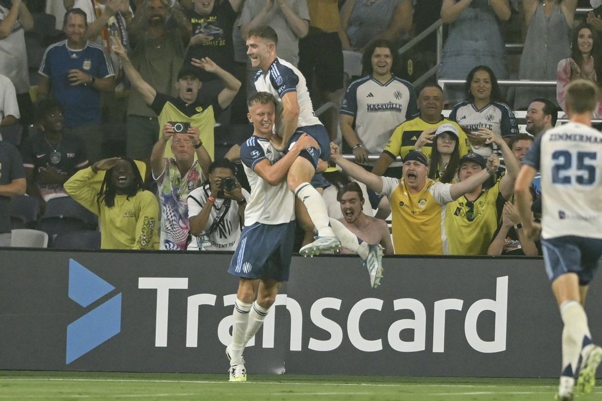 Aug 23, 2025; Nashville, Tennessee, USA;  Nashville SC forward Sam Surridge (9) celebrates his goal with his teammates against the Orlando City during the first half at Geodis Park. Mandatory Credit: Steve Roberts-Imagn Images