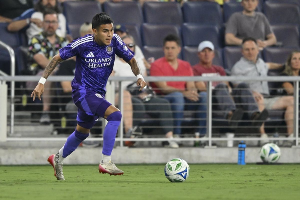 Aug 23, 2025; Nashville, Tennessee, USA;  Orlando City defender Kyle Smith (24) dribbles the ball against the Nashville SC during the first half at Geodis Park. Mandatory Credit: Steve Roberts-Imagn Images