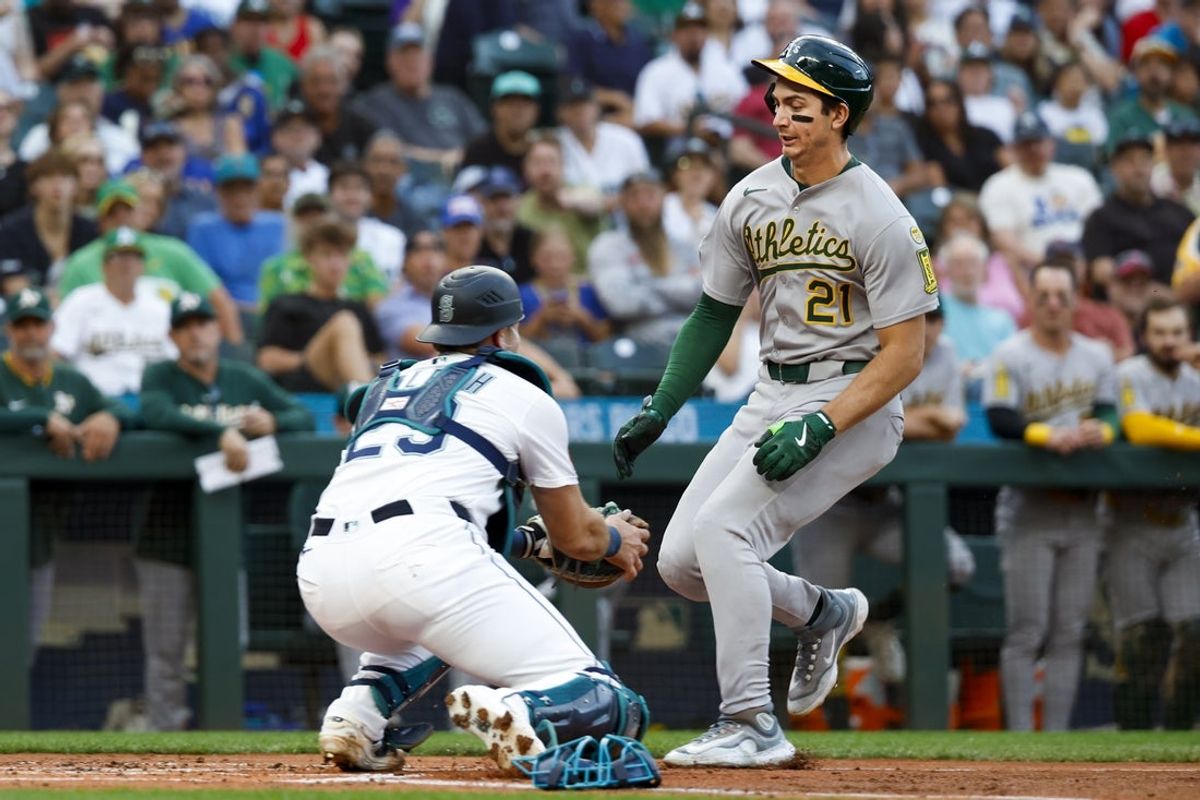 Aug 23, 2025; Seattle, Washington, USA; Seattle Mariners catcher Cal Raleigh (29) tags out Athletics left fielder Tyler Soderstrom (21) during the second inning at T-Mobile Park. Mandatory Credit: Joe Nicholson-Imagn Images