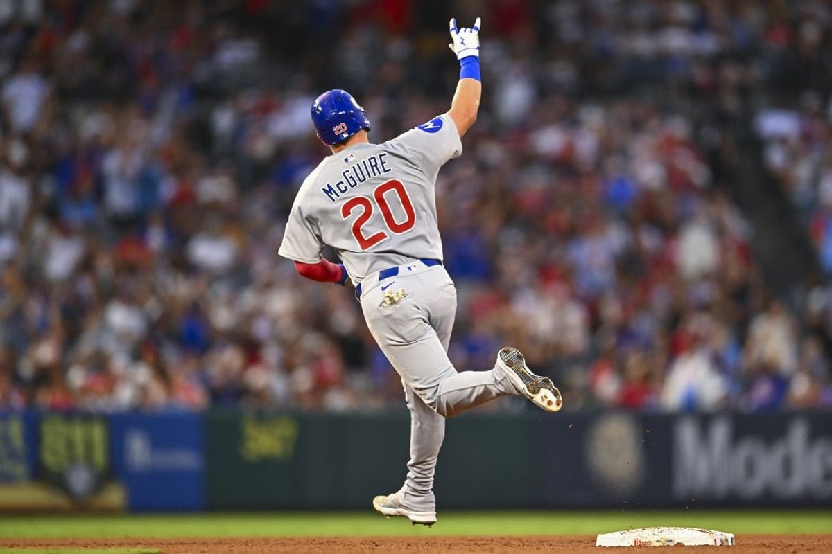 Aug 23, 2025; Anaheim, California, USA; Chicago Cubs catcher Reese McGuire (20) hits a grand slam against the Los Angeles Angels during the fourth inning at Angel Stadium. Mandatory Credit: Jonathan Hui-Imagn Images