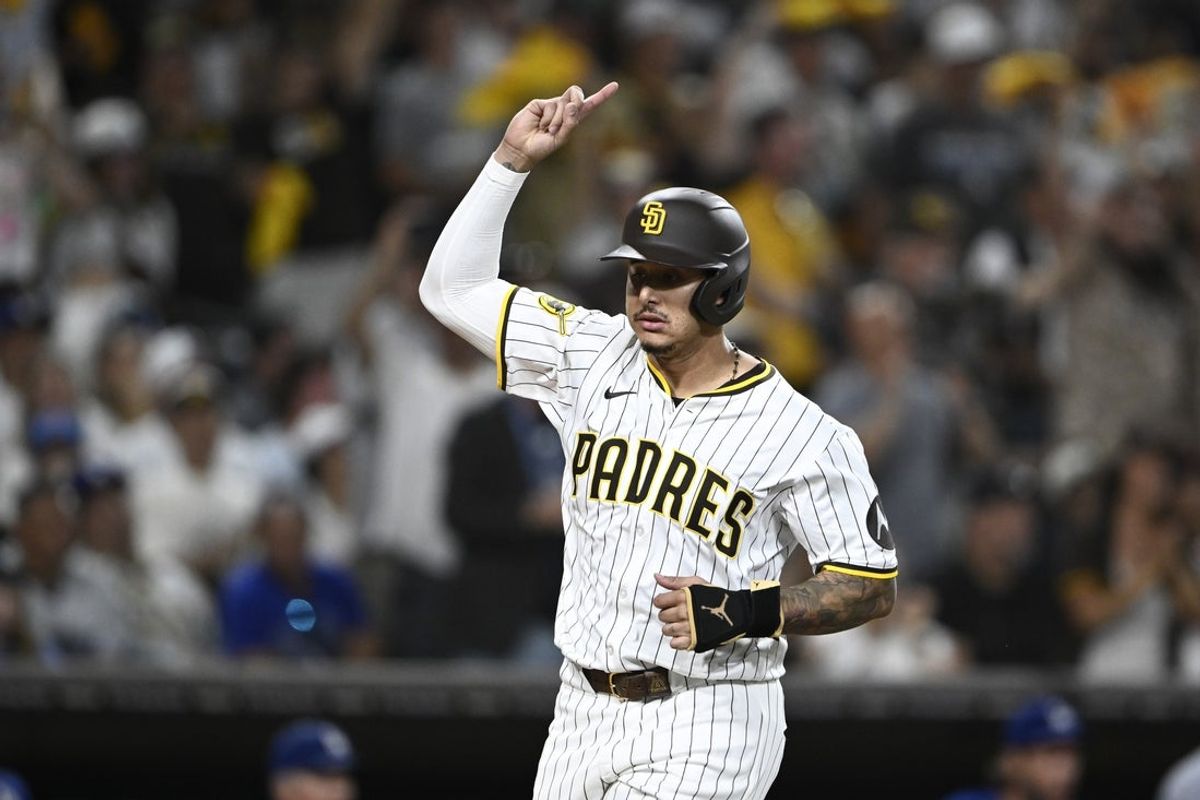 Aug 23, 2025; San Diego, California, USA; San Diego Padres third baseman Manny Machado (13) celebrates as he scores during the eighth inning against the Los Angeles Dodgers at Petco Park. Mandatory Credit: Denis Poroy-Imagn Images