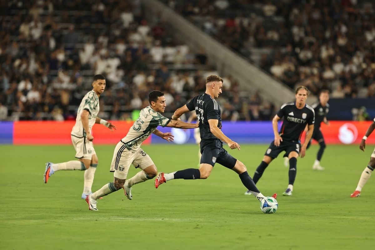 Aug 23, 2025; San Diego, California, USA; San Diego FC defender Christopher McVey (97) prepares to the pass the ball while defending from the Portland Timbers during the first half at Snapdragon Stadium. Mandatory Credit: Julia Kapros-Imagn Images