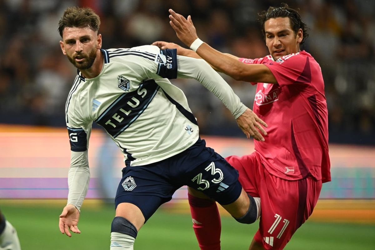 Aug 23, 2025; Vancouver, British Columbia, CAN;  Vancouver Whitecaps FC defender Tristan Blackmon (33) battles for the ball against St. Louis City SC forward Simon Becher (11) during the second half at BC Place. Mandatory Credit: Anne-Marie Sorvin-Imagn Images