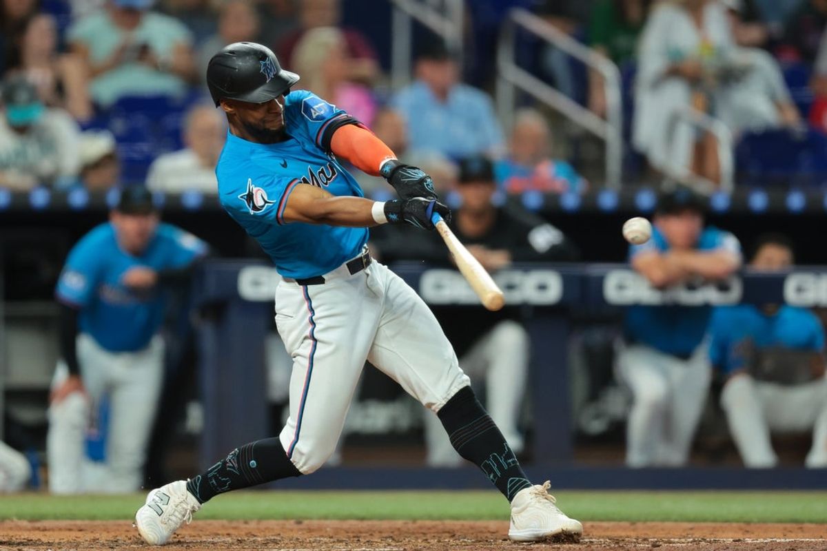 Aug 24, 2025; Miami, Florida, USA; Miami Marlins shortstop Otto Lopez (6) hits a single against the Toronto Blue Jays during the fourth inning at loanDepot Park. Mandatory Credit: Sam Navarro-Imagn Images