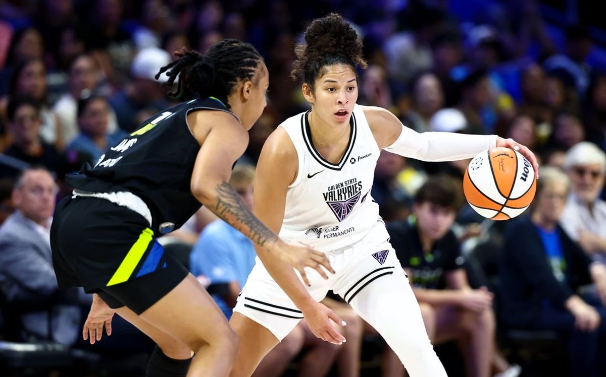 Aug 24, 2025; Arlington, Texas, USA;  Golden State Valkyries guard Veronica Burton (22) controls the ball as Dallas Wings guard Aziaha James (10) defends during the first half at College Park Center. Mandatory Credit: Kevin Jairaj-Imagn Images