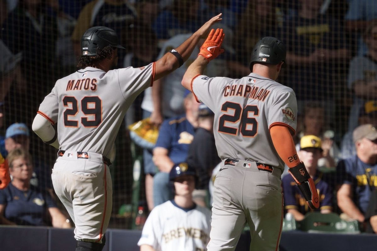 Aug 24, 2025; Milwaukee, Wisconsin, USA;  San Francisco Giants right fielder Luis Matos (29) and third baseman Matt Chapman (26) high five after scoring during the ninth inning against the Milwaukee Brewers at American Family Field. Mandatory Credit: Jeff Hanisch-Imagn Images