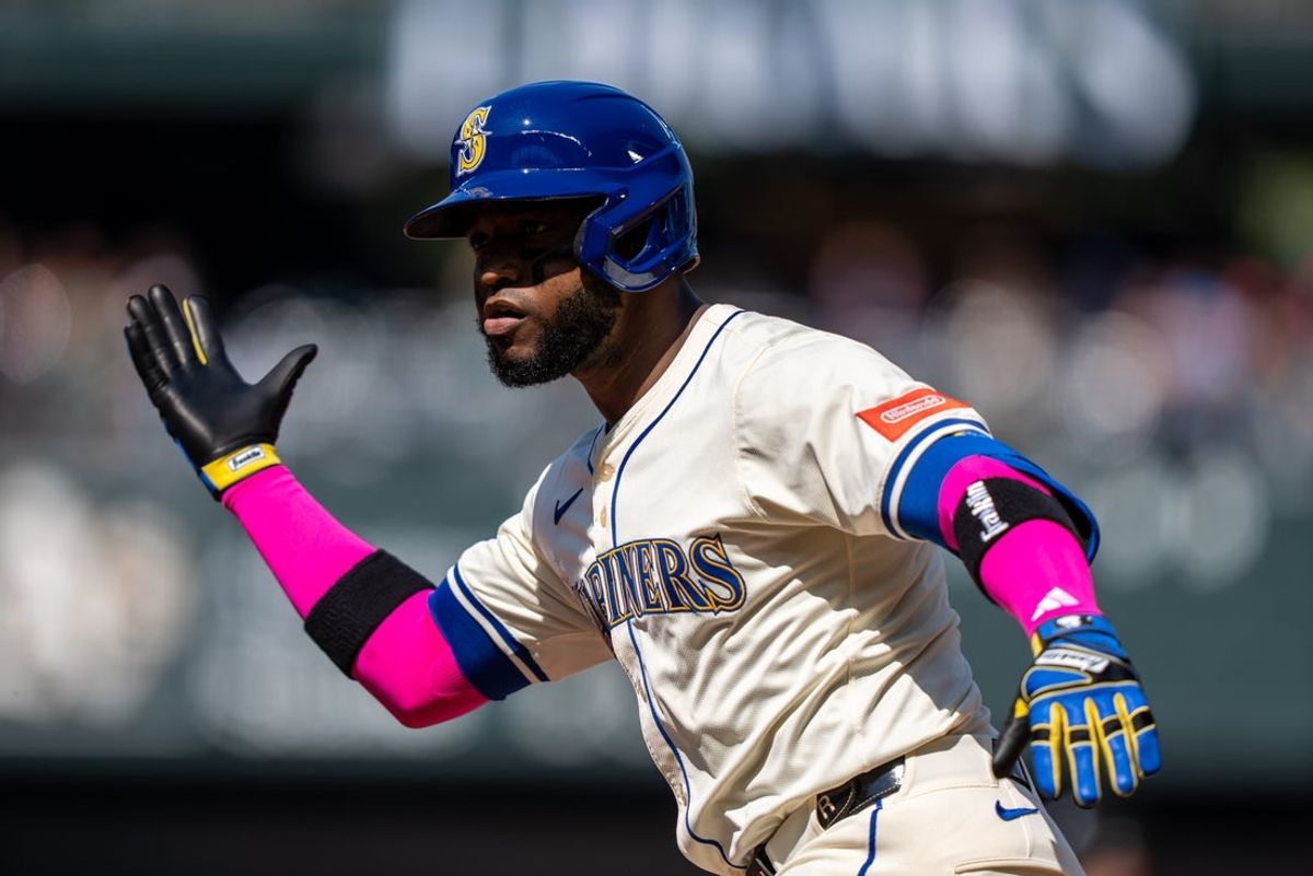 Aug 24, 2025; Seattle, Washington, USA; Seattle Mariners right fielder Victor Robles (10) celebrates at second base after hitting a two-run single during the third inning against the Athletics at T-Mobile Park. Mandatory Credit: Stephen Brashear-Imagn Images