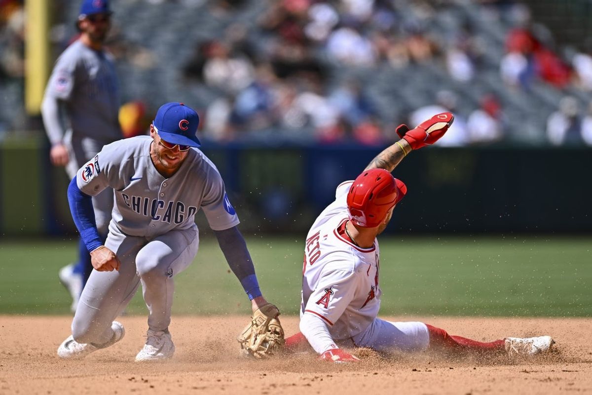 Aug 24, 2025; Anaheim, California, USA; Los Angeles Angels shortstop Zach Neto (9) steals second base against Chicago Cubs second baseman Nico Hoerner (2) during the sixth inning at Angel Stadium. Mandatory Credit: Jonathan Hui-Imagn Images