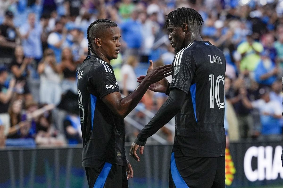 Aug 24, 2025; Charlotte, North Carolina, USA; Charlotte FC forward Kerwin Vargas (18) and forward Wilfried Zaha (10) celebrate his first half goal against the New York Red Bulls during the first half at Bank of America Stadium. Mandatory Credit: Jim Dedmon-Imagn Images