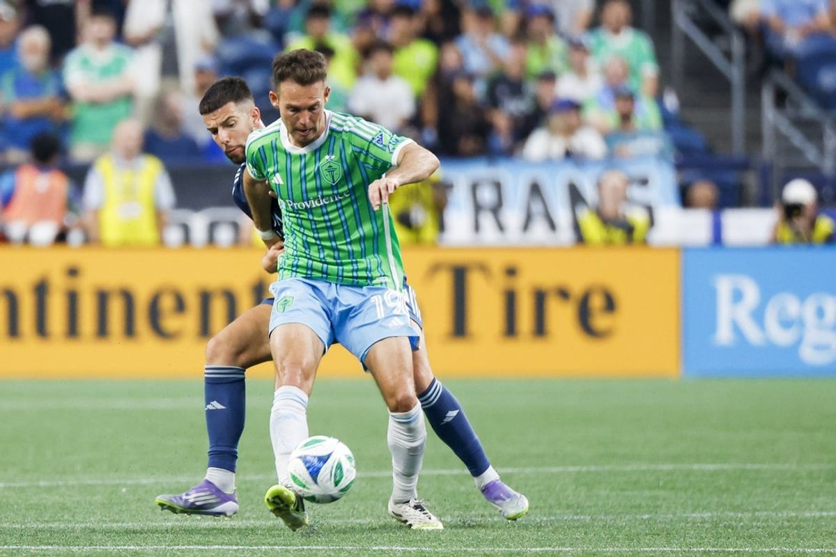 Aug 24, 2025; Seattle, Washington, USA; Seattle Sounders FC forward Danny Musovski (19) passes away from Sporting Kansas City forward Khiry Shelton (11) during the second half at Lumen Field. Mandatory Credit: Joe Nicholson-Imagn Images