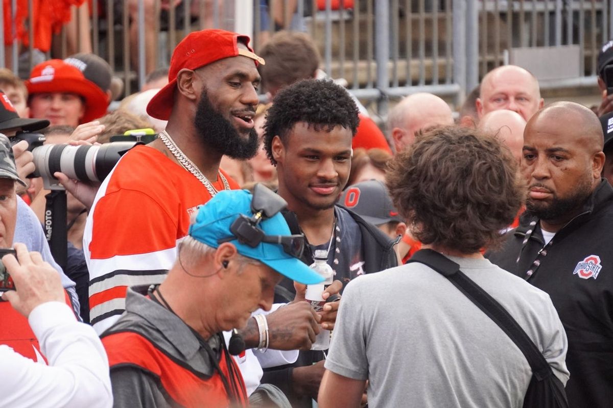 LeBron James and his son Bronny James look on before a football game between the Ohio State Buckeyes and Notre Dame Fighting Irish at Ohio Stadium.