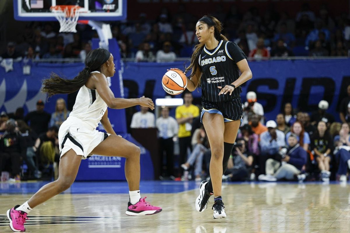Aug 25, 2025; Chicago, Illinois, USA; Chicago Sky forward Angel Reese (5) brings the ball up court against Las Vegas Aces guard Jackie Young (0) during the first half at Wintrust Arena. Mandatory Credit: Kamil Krzaczynski-Imagn Images