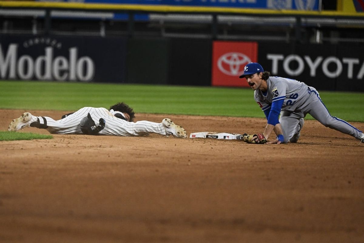 Aug 25, 2025; Chicago, Illinois, USA;  Chicago White Sox third baseman Miguel Vargas (20) slides safely into second base past Kansas City Royals second baseman Adam Frazier (26) after hitting a double during the seventh inning at Rate Field. Mandatory Credit: Matt Marton-Imagn Images