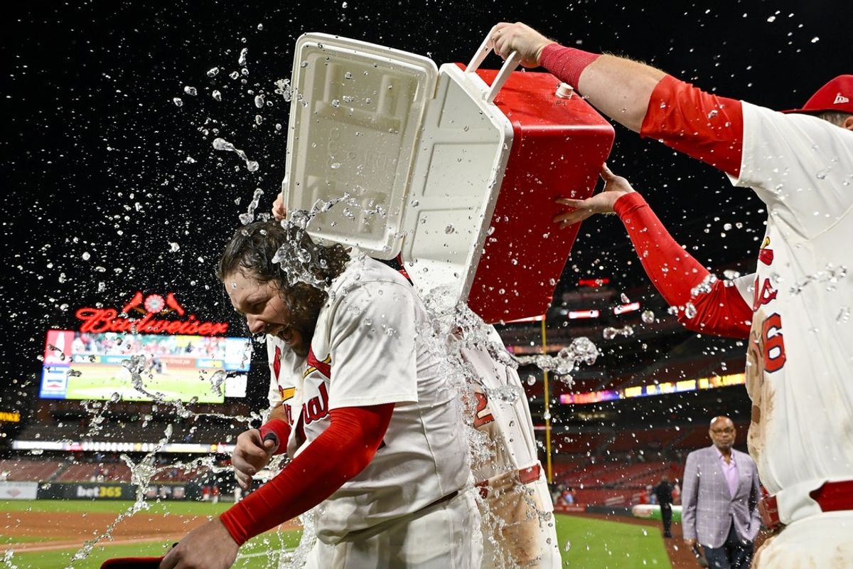 Aug 25, 2025; St. Louis, Missouri, USA;  St. Louis Cardinals first baseman Alec Burleson (41) is doused with water by teammates after hitting a walk-off solo home run against the Pittsburgh Pirates during the ninth inning at Busch Stadium. Mandatory Credit: Jeff Curry-Imagn Images