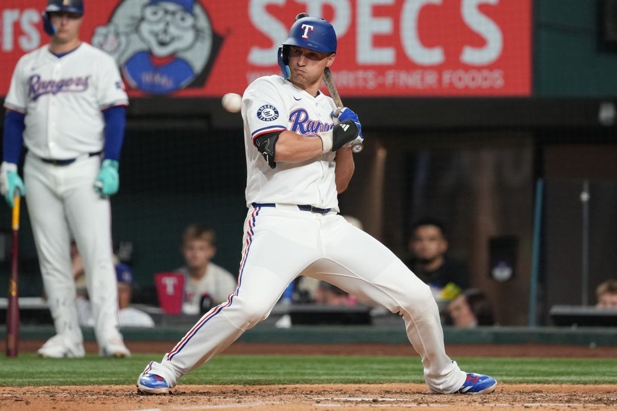 Aug 25, 2025; Arlington, Texas, USA; Texas Rangers shortstop Corey Seager (5) dodges an inside pitch during the sixth inning against the Los Angeles Angels at Globe Life Field. Mandatory Credit: Jim Cowsert-Imagn Images