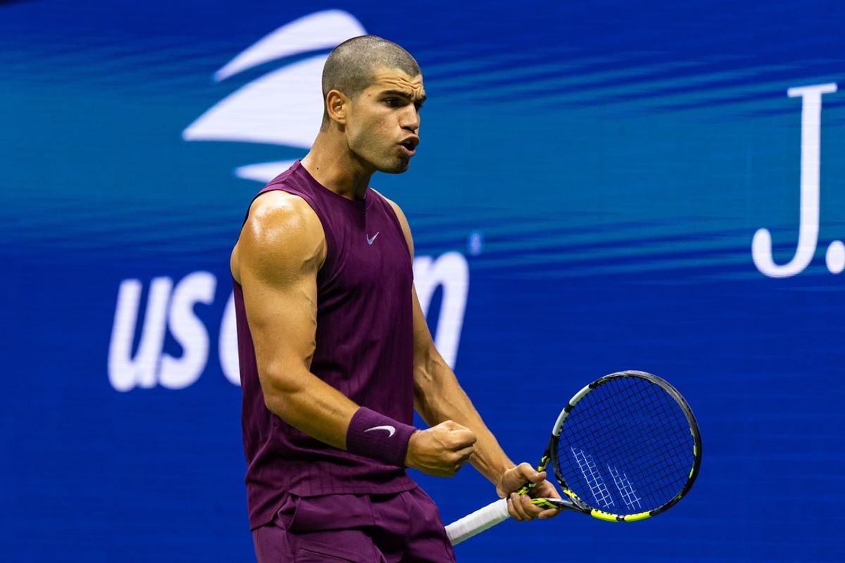 Aug 25, 2025; Flushing, NY, USA; Carlos Alcaraz of Spain in action against Reilly Opelka of the United States in the first round of the men’s singles at the US Open at Arthur Ashe Stadium in Billie Jean King National Tennis Centre. Mandatory Credit: Mike Frey-Imagn Images