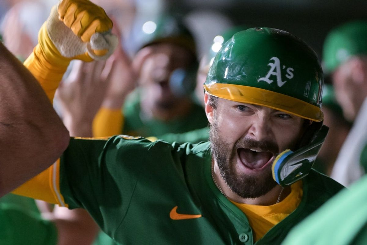 Aug 25, 2025; West Sacramento, California, USA; Athletics catcher Shea Langeliers (23) celebrates with team mates after hitting a home run against the Detroit Tigers during the seventh inning at Sutter Health Park. Mandatory Credit: Ed Szczepanski-Imagn Images