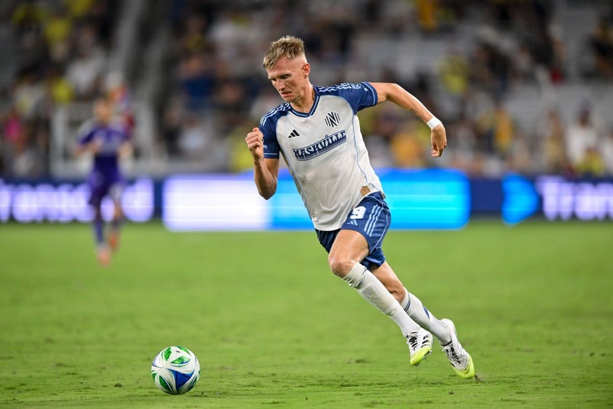 Aug 23, 2025; Nashville, Tennessee, USA;  Nashville SC forward Sam Surridge (9) dribbles the ball against the Orlando City during the second half at Geodis Park. Mandatory Credit: Steve Roberts-Imagn Images