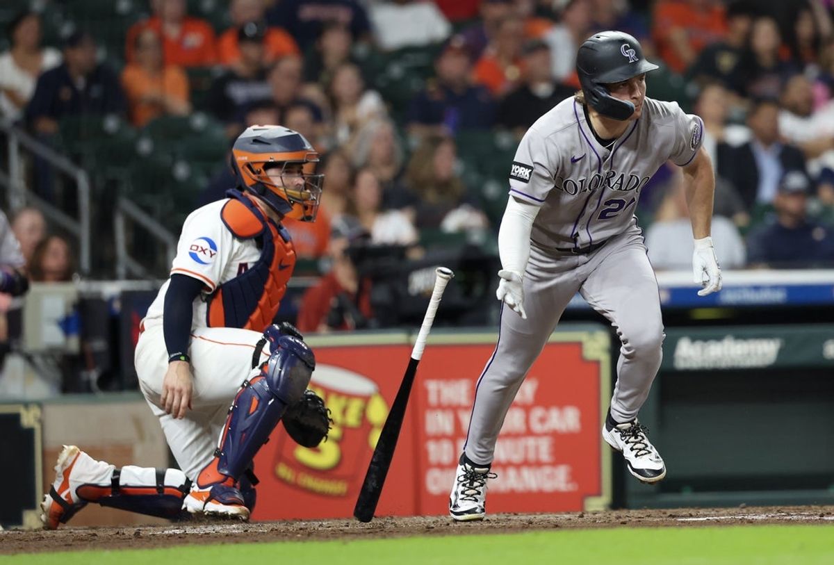 Aug 26, 2025; Houston, Texas, USA; Colorado Rockies right fielder Mickey Moniak (22) hits a RBI single against the Houston Astros in the third inning at Daikin Park. Mandatory Credit: Thomas Shea-Imagn Images