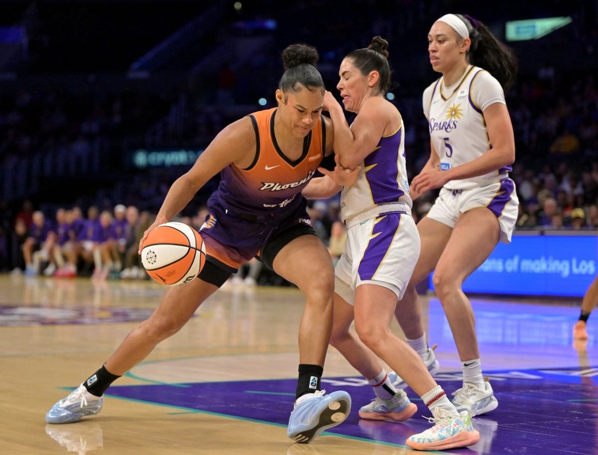 Aug 26, 2025; Los Angeles, California, USA;  Phoenix Mercury forward Satou Sabally (0) is defended by Los Angeles Sparks guard Kelsey Plum (10) as she drives to the basket during the first half at Crypto.com Arena. Mandatory Credit: Jayne Kamin-Oncea-Imagn Images