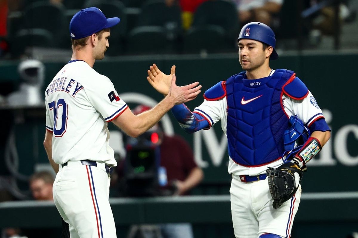 Aug 27, 2025; Arlington, Texas, USA;  Texas Rangers relief pitcher Caleb Boushley (70) celebrates with Texas Rangers catcher Kyle Higashioka (11) after the game against the Los Angeles Angels at Globe Life Field. Mandatory Credit: Kevin Jairaj-Imagn Images