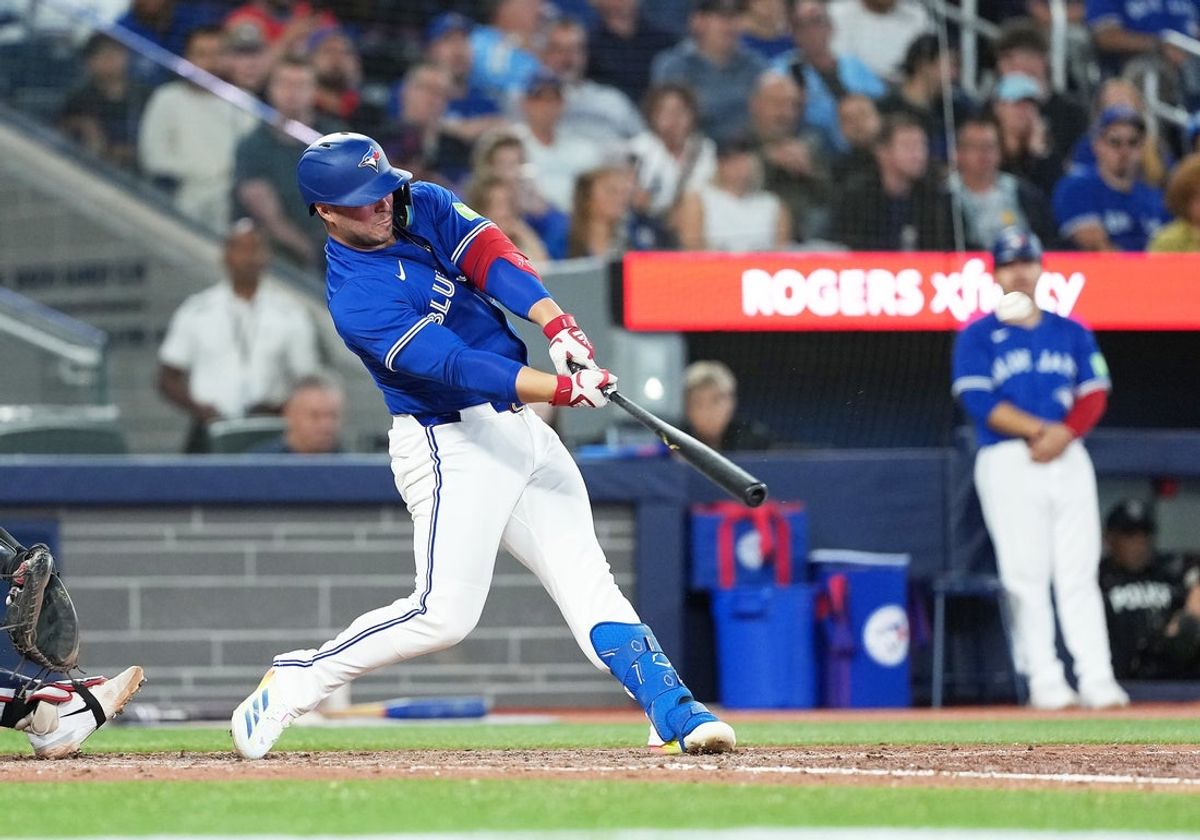 Aug 27, 2025; Toronto, Ontario, CAN; Toronto Blue Jays pinch hitter Ty France (2) hits a home run against the Minnesota Twins during the eighth inning at Rogers Centre. Mandatory Credit: Nick Turchiaro-Imagn Images